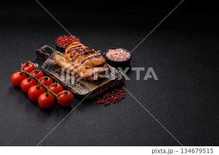 Grilled boneless chicken legs baked on the barbecue for lunch. Grilled chicken as a background 134679515