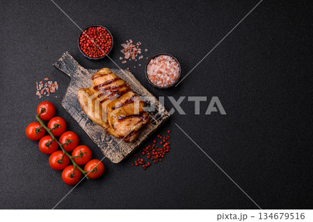 Grilled boneless chicken legs baked on the barbecue for lunch. Grilled chicken as a background Grilled boneless chicken legs baked on the barbecue for lunch. Grilled chicken as a background 134679516