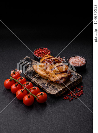 Grilled boneless chicken legs baked on the barbecue for lunch. Grilled chicken as a background Grilled boneless chicken legs baked on the barbecue for lunch. Grilled chicken as a background 134679518