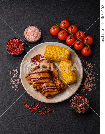 Grilled boneless chicken legs baked on the barbecue for lunch. Grilled chicken as a background Grilled boneless chicken legs baked on the barbecue for lunch. Grilled chicken as a background 134679552