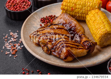 Grilled boneless chicken legs baked on the barbecue for lunch. Grilled chicken as a background 134679554