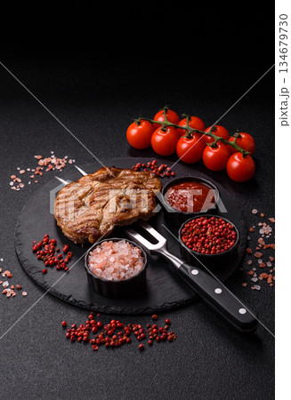 Grilled beef or pork steak, healthy restaurant food for lunch. Barbecue steak as a background Grilled beef or pork steak, healthy restaurant food for lunch. Barbecue steak as a background 134679730