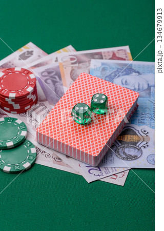 Casino game in the Great Britain, pound sterling money, chips, cards. Gambling in the England Casino game in the Great Britain, pound sterling money, chips, cards. Gambling in the England 134679913