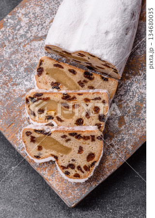 Stollen, a German Christmas pastry for the winter holidays. Stollen as a food background Stollen, a German Christmas pastry for the winter holidays. Stollen as a food background 134680035