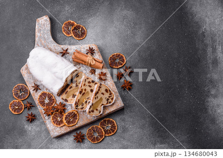 Stollen, a German Christmas pastry for the winter holidays. Stollen as a food background Stollen, a German Christmas pastry for the winter holidays. Stollen as a food background 134680043