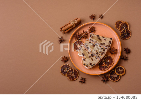 Stollen, a German Christmas pastry for the winter holidays. Stollen as a food background Stollen, a German Christmas pastry for the winter holidays. Stollen as a food background 134680085