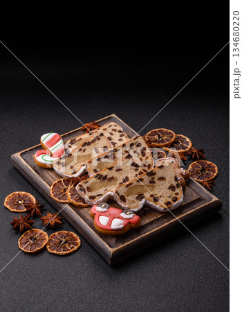 Stollen, a German Christmas pastry for the winter holidays. Stollen as a food background Stollen, a German Christmas pastry for the winter holidays. Stollen as a food background 134680220