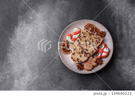 Stollen, a German Christmas pastry for the winter holidays. Stollen as a food background Stollen, a German Christmas pastry for the winter holidays. Stollen as a food background 134680222