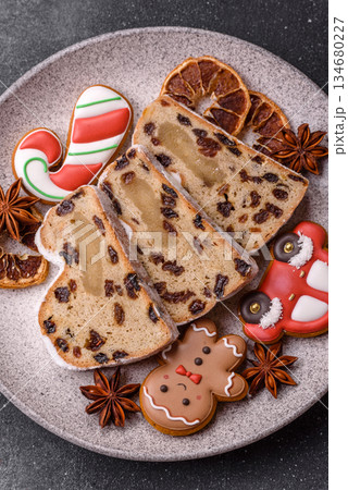 Stollen, a German Christmas pastry for the winter holidays. Stollen as a food background Stollen, a German Christmas pastry for the winter holidays. Stollen as a food background 134680227