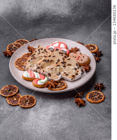Stollen, a German Christmas pastry for the winter holidays. Stollen as a food background Stollen, a German Christmas pastry for the winter holidays. Stollen as a food background 134680236