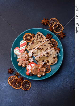 Stollen, a German Christmas pastry for the winter holidays. Stollen as a food background Stollen, a German Christmas pastry for the winter holidays. Stollen as a food background 134680250