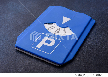 A parking disc, permit, or ticket for measuring time and paying municipal services. A parking disc 134680256