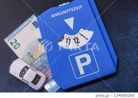 A parking disc, permit, or ticket for measuring time and paying municipal services. A parking disc 134680260