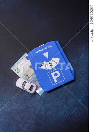 A parking disc, permit, or ticket for measuring time and paying municipal services. A parking disc 134680264