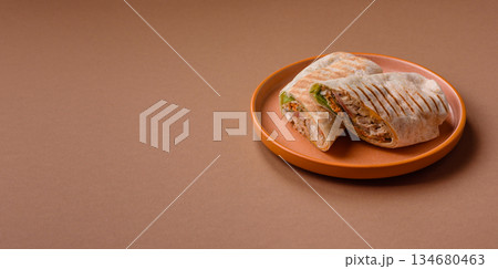 Shawarma with chicken or beef, tortilla roll, and vegetables. Shawarma with meat 134680463