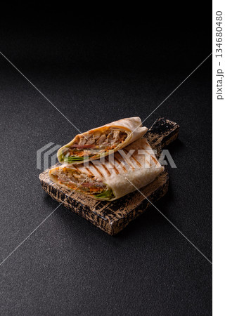 Shawarma with chicken or beef, tortilla roll, and vegetables. Shawarma with meat 134680480