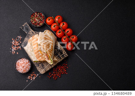 Shawarma with chicken or beef, tortilla roll, and vegetables. Shawarma with meat 134680489