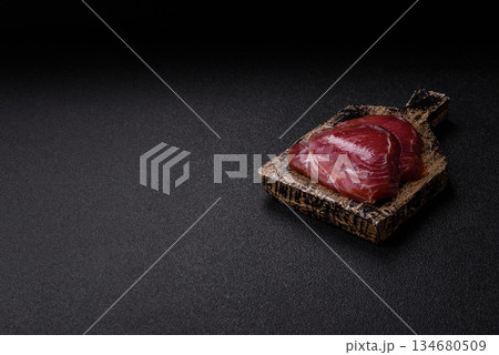 Tuna steak for sashimi or sushi, smoked fish. Tuna steak as a food background Tuna steak for sashimi or sushi, smoked fish. Tuna steak as a food background 134680509