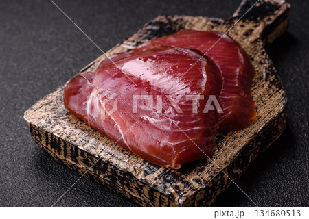 Tuna steak for sashimi or sushi, smoked fish. Tuna steak as a food background Tuna steak for sashimi or sushi, smoked fish. Tuna steak as a food background 134680513