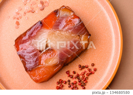 Tuna and salmon roll, smoked fish. Tuna and salmon roll as a food background Tuna and salmon roll, smoked fish. Tuna and salmon roll as a food background 134680580