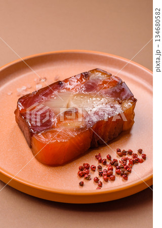 Tuna and salmon roll, smoked fish. Tuna and salmon roll as a food background Tuna and salmon roll, smoked fish. Tuna and salmon roll as a food background 134680582