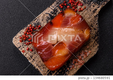 Tuna and salmon roll, smoked fish. Tuna and salmon roll as a food background Tuna and salmon roll, smoked fish. Tuna and salmon roll as a food background 134680591