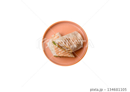Shawarma with chicken or beef, tortilla roll, and vegetables. Shawarma with meat 134681105