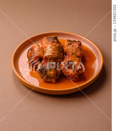 Hake fish cooked in pieces in tomato sauce, stew with peppers and carrots. Hake fish in tomato 134681502