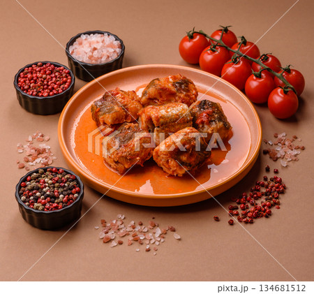 Hake fish cooked in pieces in tomato sauce, stew with peppers and carrots. Hake fish in tomato Hake fish cooked in pieces in tomato sauce, stew with peppers and carrots. Hake fish in tomato 134681512