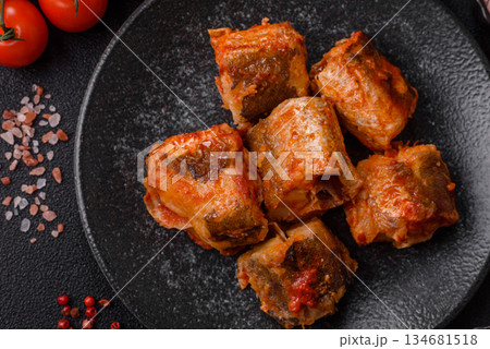 Hake fish cooked in pieces in tomato sauce, stew with peppers and carrots. Hake fish in tomato Hake fish cooked in pieces in tomato sauce, stew with peppers and carrots. Hake fish in tomato 134681518