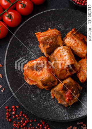 Hake fish cooked in pieces in tomato sauce, stew with peppers and carrots. Hake fish in tomato 134681519