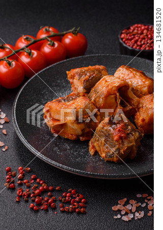 Hake fish cooked in pieces in tomato sauce, stew with peppers and carrots. Hake fish in tomato 134681520