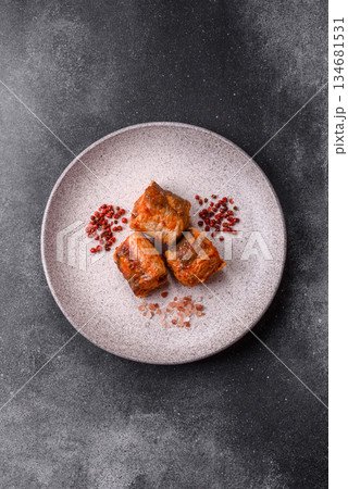 Hake fish cooked in pieces in tomato sauce, stew with peppers and carrots. Hake fish in tomato 134681531