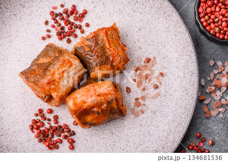 Hake fish cooked in pieces in tomato sauce, stew with peppers and carrots. Hake fish in tomato Hake fish cooked in pieces in tomato sauce, stew with peppers and carrots. Hake fish in tomato 134681536