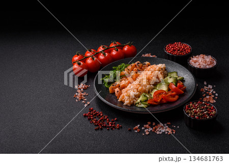 A food bowl with salmon, rice, avocado, tomatoes, and cucumbers. A salmon bowl 134681763