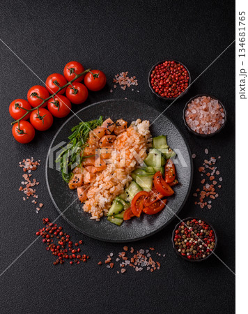 A food bowl with salmon, rice, avocado, tomatoes, and cucumbers. A salmon bowl A food bowl with salmon, rice, avocado, tomatoes, and cucumbers. A salmon bowl 134681765