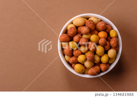 Food, nuts coated with salt and paprika, peanuts as a source of protein. Salted peanuts 134681988