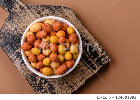 Food, nuts coated with salt and paprika, peanuts as a source of protein. Salted peanuts Food, nuts coated with salt and paprika, peanuts as a source of protein. Salted peanuts 134681992