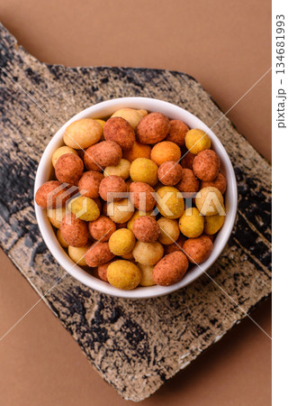 Food, nuts coated with salt and paprika, peanuts as a source of protein. Salted peanuts 134681993