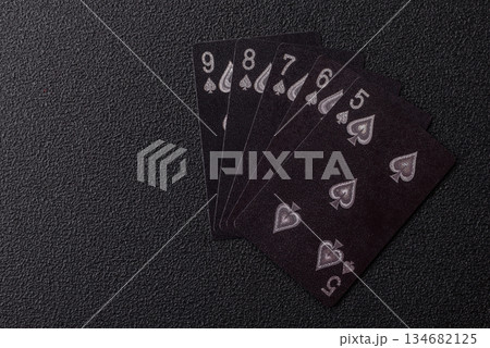 Playing card game poker in casino with chips, bets and risk. Cards and chips on black felt Playing card game poker in casino with chips, bets and risk. Cards and chips on black felt 134682125