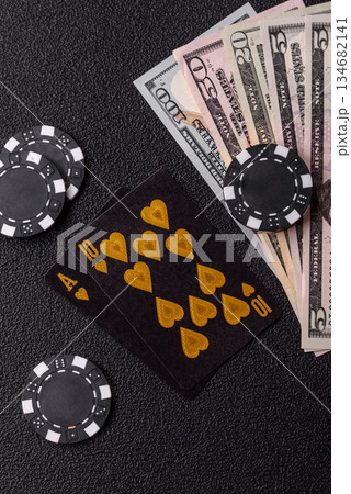 Playing blackjack or baccarat card game in casino with chips. Cards and chips on black felt 134682141