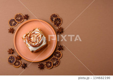 Cinnabon, a sweet cinnamon pastry, a high calorie bun or roll. Cinnabon with cinnamon Cinnabon, a sweet cinnamon pastry, a high calorie bun or roll. Cinnabon with cinnamon 134682190