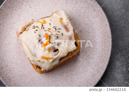 Cinnabon, a sweet cinnamon pastry, a high calorie bun or roll. Cinnabon with cinnamon Cinnabon, a sweet cinnamon pastry, a high calorie bun or roll. Cinnabon with cinnamon 134682218