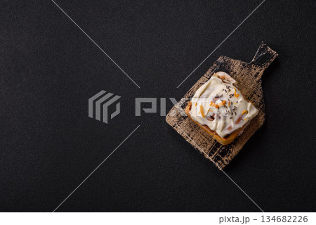 Cinnabon, a sweet cinnamon pastry, a high calorie bun or roll. Cinnabon with cinnamon Cinnabon, a sweet cinnamon pastry, a high calorie bun or roll. Cinnabon with cinnamon 134682226