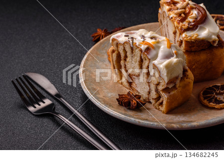 Cinnabon, a sweet cinnamon pastry, a high calorie bun or roll. Cinnabon with cinnamon 134682245
