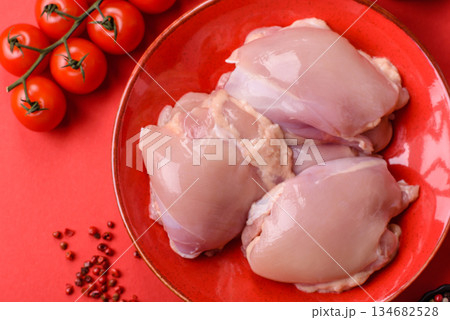 Chicken thigh fillet, skinless and boneless meat for grilling or barbecue. Chicken thigh fillet Chicken thigh fillet, skinless and boneless meat for grilling or barbecue. Chicken thigh fillet 134682528