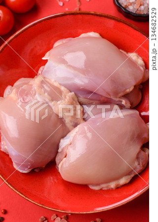 Chicken thigh fillet, skinless and boneless meat for grilling or barbecue. Chicken thigh fillet 134682529