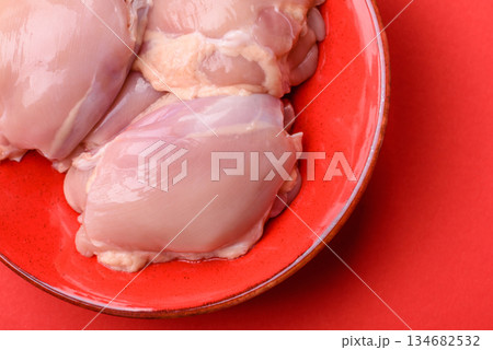 Chicken thigh fillet, skinless and boneless meat for grilling or barbecue. Chicken thigh fillet 134682532