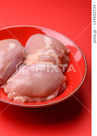 Chicken thigh fillet, skinless and boneless meat for grilling or barbecue. Chicken thigh fillet 134682534