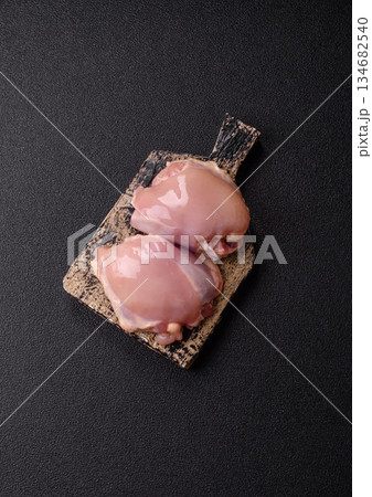 Chicken thigh fillet, skinless and boneless meat for grilling or barbecue. Chicken thigh fillet Chicken thigh fillet, skinless and boneless meat for grilling or barbecue. Chicken thigh fillet 134682540